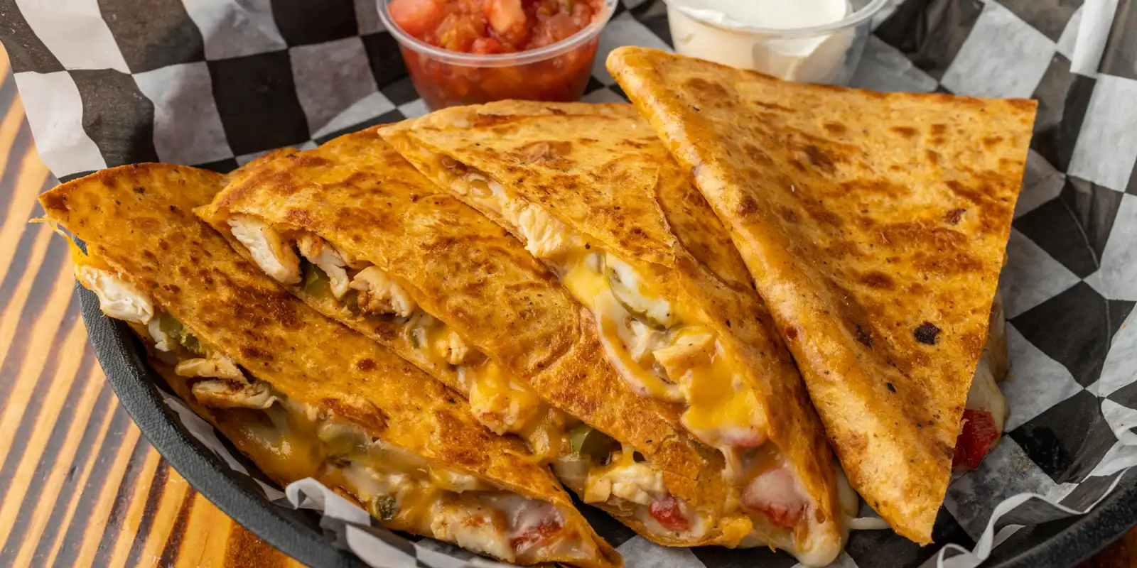 chicken quesadilla with salsa and sour cream